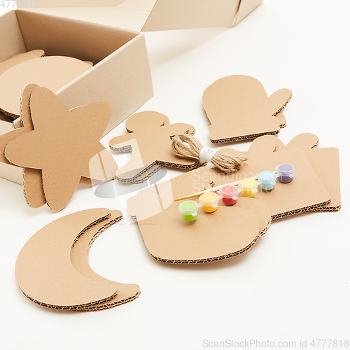 Image of DIY christmas decorations from cardboard paper. Homemade Christmas ornament from reused paper. Craft ideas for kids.