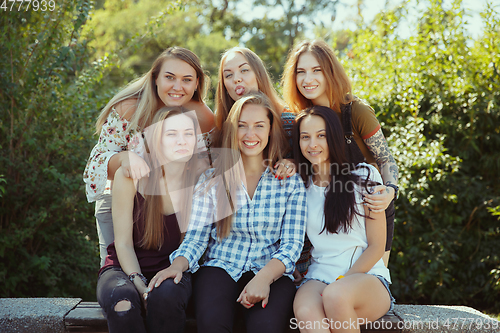 Image of Happy women outdoors on sunny day. Girl power concept.