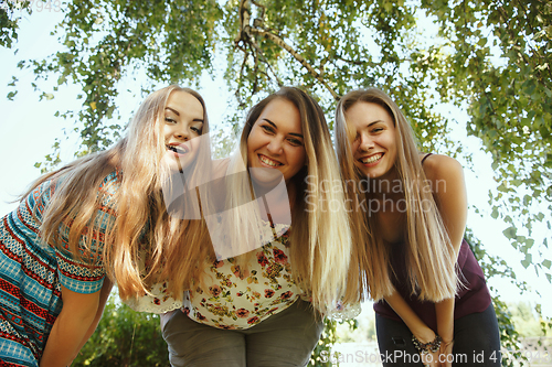 Image of Happy women outdoors on sunny day. Girl power concept.