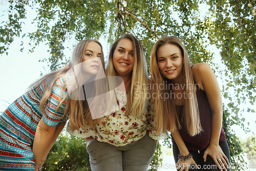 Image of Happy women outdoors on sunny day. Girl power concept.