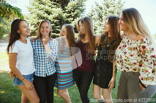 Image of Happy women outdoors on sunny day. Girl power concept.