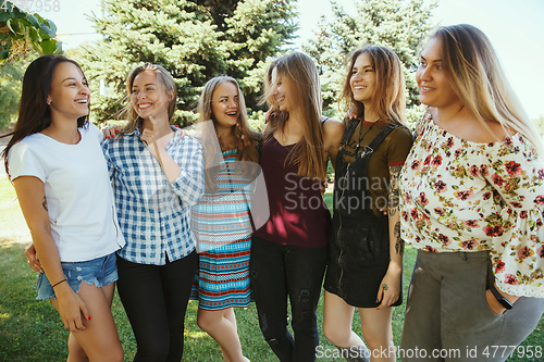 Image of Happy women outdoors on sunny day. Girl power concept.