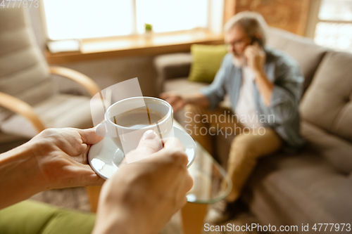 Image of Senior man working with laptop at home - concept of home studying