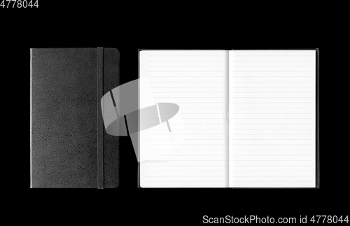 Image of Closed and open notebooks isolated on black