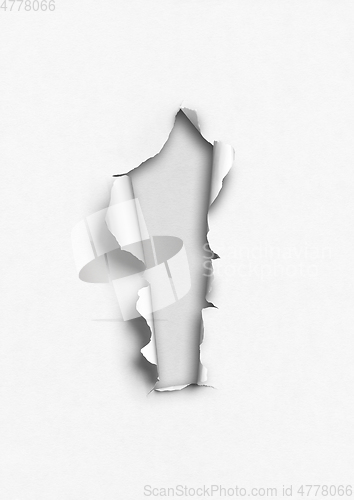 Image of White torn paper with hole