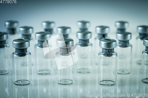 Image of Vaccine glass bottles on grey background