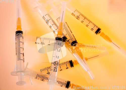 Image of Syringes on orange background