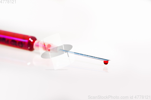 Image of Syringe with blood on white background