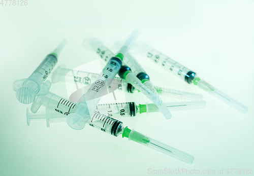 Image of Syringes on blue background