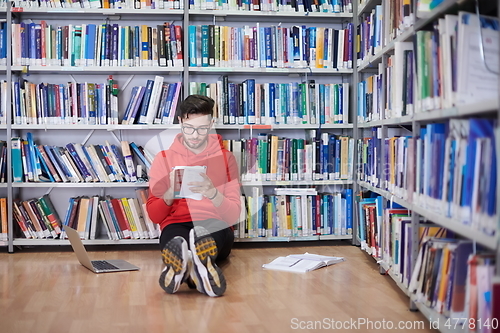 Image of the students uses a notebook, laptop and a school library