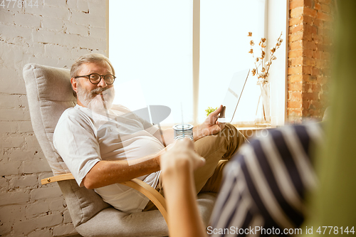 Image of Senior man working with tablet at home - concept of home studying