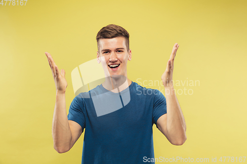 Image of Caucasian young man\'s half-length portrait on yellow background