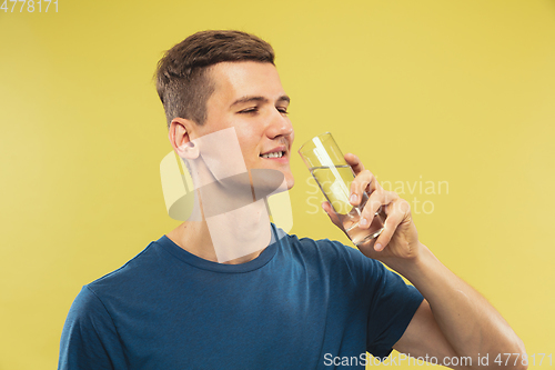 Image of Caucasian young man\'s half-length portrait on yellow background