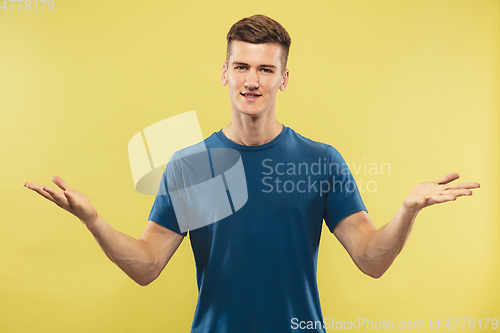 Image of Caucasian young man\'s half-length portrait on yellow background