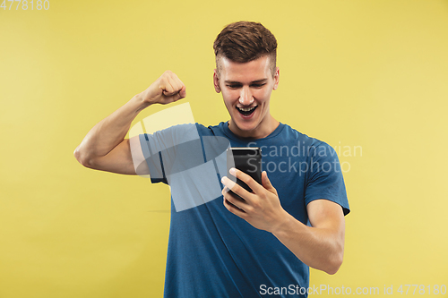 Image of Caucasian young man\'s half-length portrait on yellow background