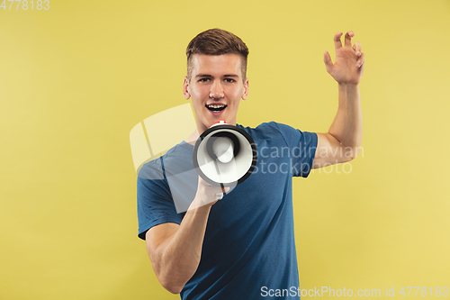 Image of Caucasian young man\'s half-length portrait on yellow background