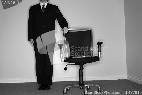 Image of Businessman and empty chair