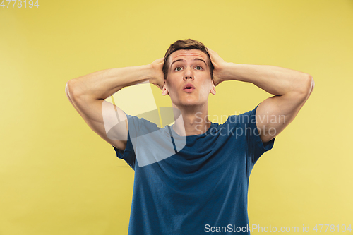 Image of Caucasian young man\'s half-length portrait on yellow background