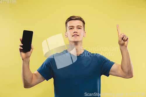 Image of Caucasian young man\'s half-length portrait on yellow background