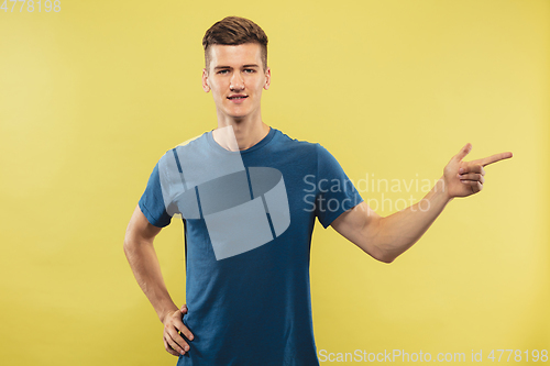 Image of Caucasian young man\'s half-length portrait on yellow background