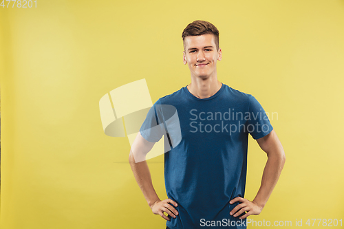 Image of Caucasian young man\'s half-length portrait on yellow background