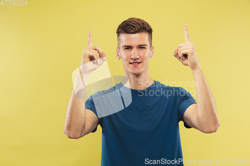 Image of Caucasian young man\'s half-length portrait on yellow background