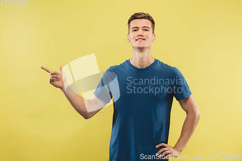 Image of Caucasian young man\'s half-length portrait on yellow background