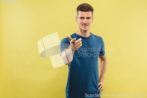 Image of Caucasian young man\'s half-length portrait on yellow background