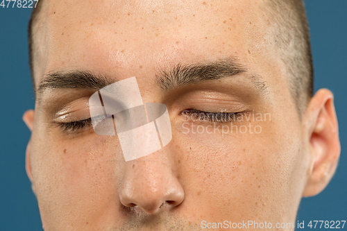 Image of Caucasian young man\'s close up shot on blue background