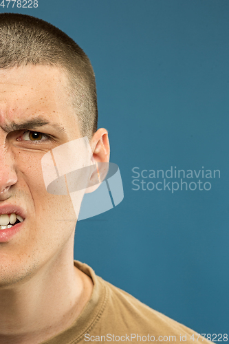 Image of Caucasian young man\'s close up shot on blue background