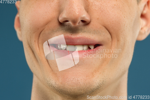 Image of Caucasian young man\'s close up shot on blue background