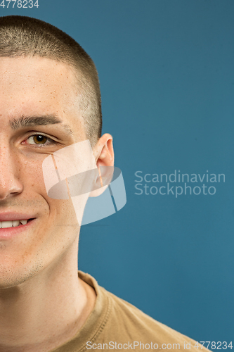 Image of Caucasian young man\'s close up shot on blue background