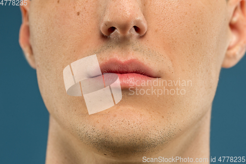 Image of Caucasian young man\'s close up shot on blue background