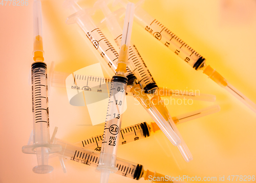 Image of Syringes on orange background