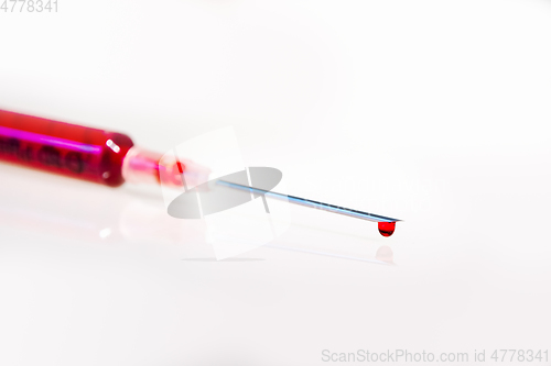 Image of Syringe with blood on white background