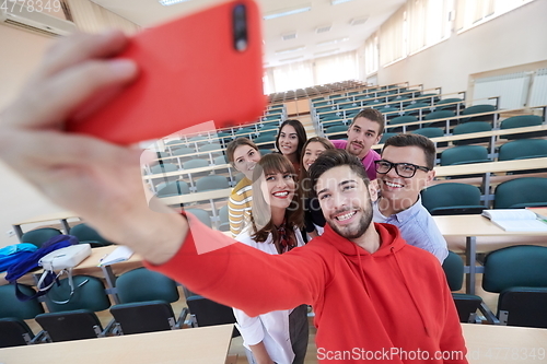 Image of Group of multiethnic teenagers taking a selfie in school