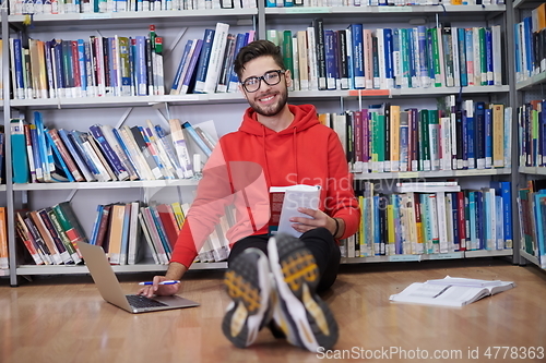 Image of the students uses a notebook, laptop and a school library