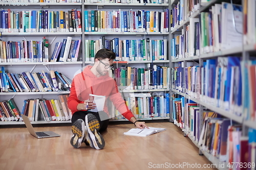 Image of the students uses a notebook, laptop and a school library