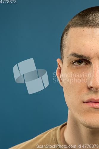 Image of Caucasian young man\'s close up shot on blue background