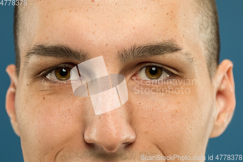 Image of Caucasian young man\'s close up shot on blue background