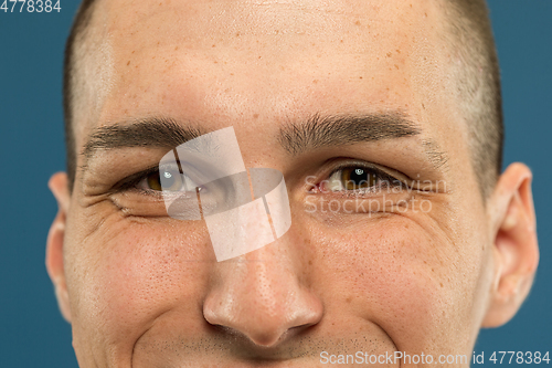 Image of Caucasian young man\'s close up shot on blue background