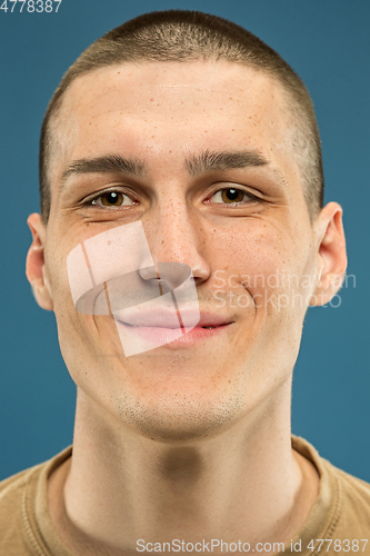 Image of Caucasian young man\'s close up shot on blue background