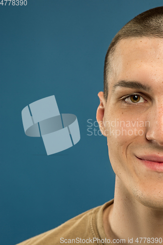 Image of Caucasian young man\'s close up shot on blue background