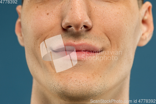 Image of Caucasian young man\'s close up shot on blue background