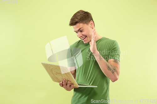 Image of Caucasian young man\'s half-length portrait on green background
