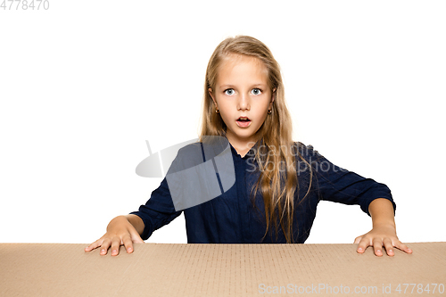 Image of Cute little girl opening the biggest postal package