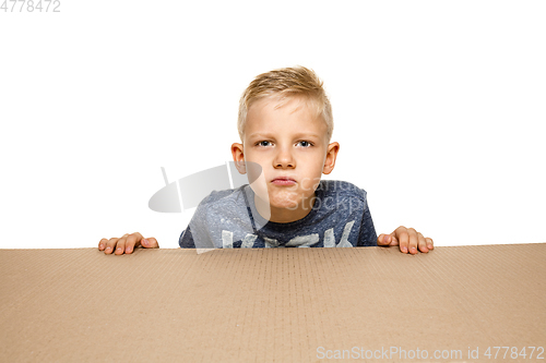 Image of Cute little boy opening the biggest postal package