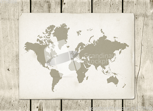 Image of Vintage world map parchment on a wooden wall