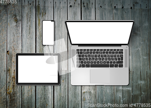 Image of Laptop, tablet and phone set mockup on a wooden background. 3D r