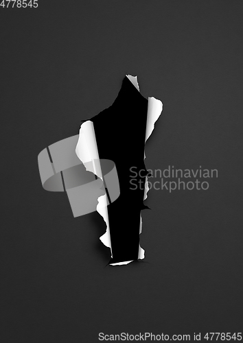 Image of Black torn paper with dark hole